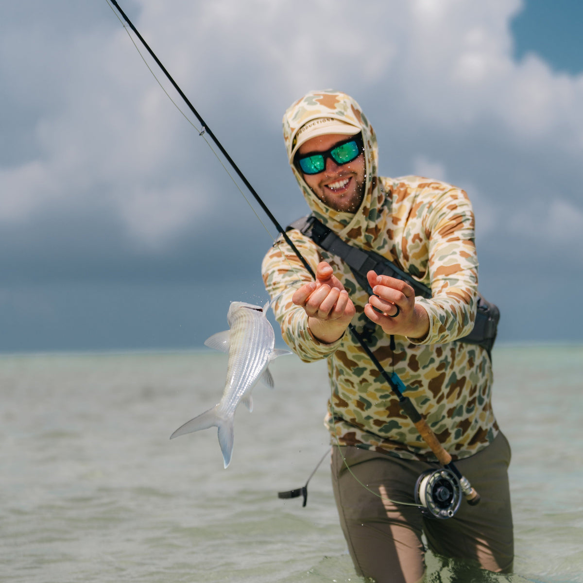 Angler holding rod rack loses control of bonefish as it flops into the water